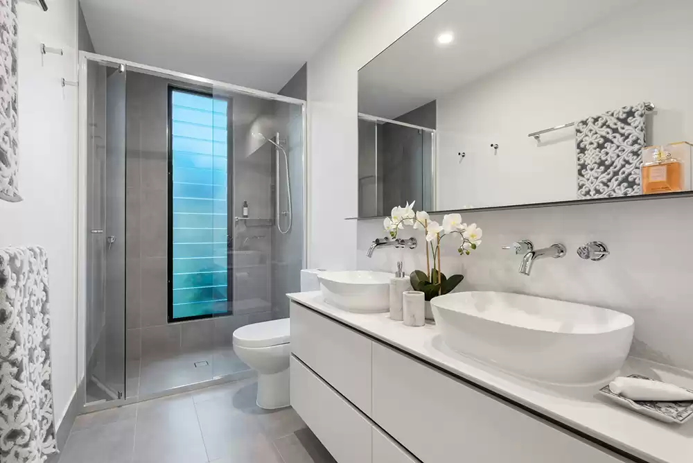 Frameless glass shower enclosure installed in a finished bathroom